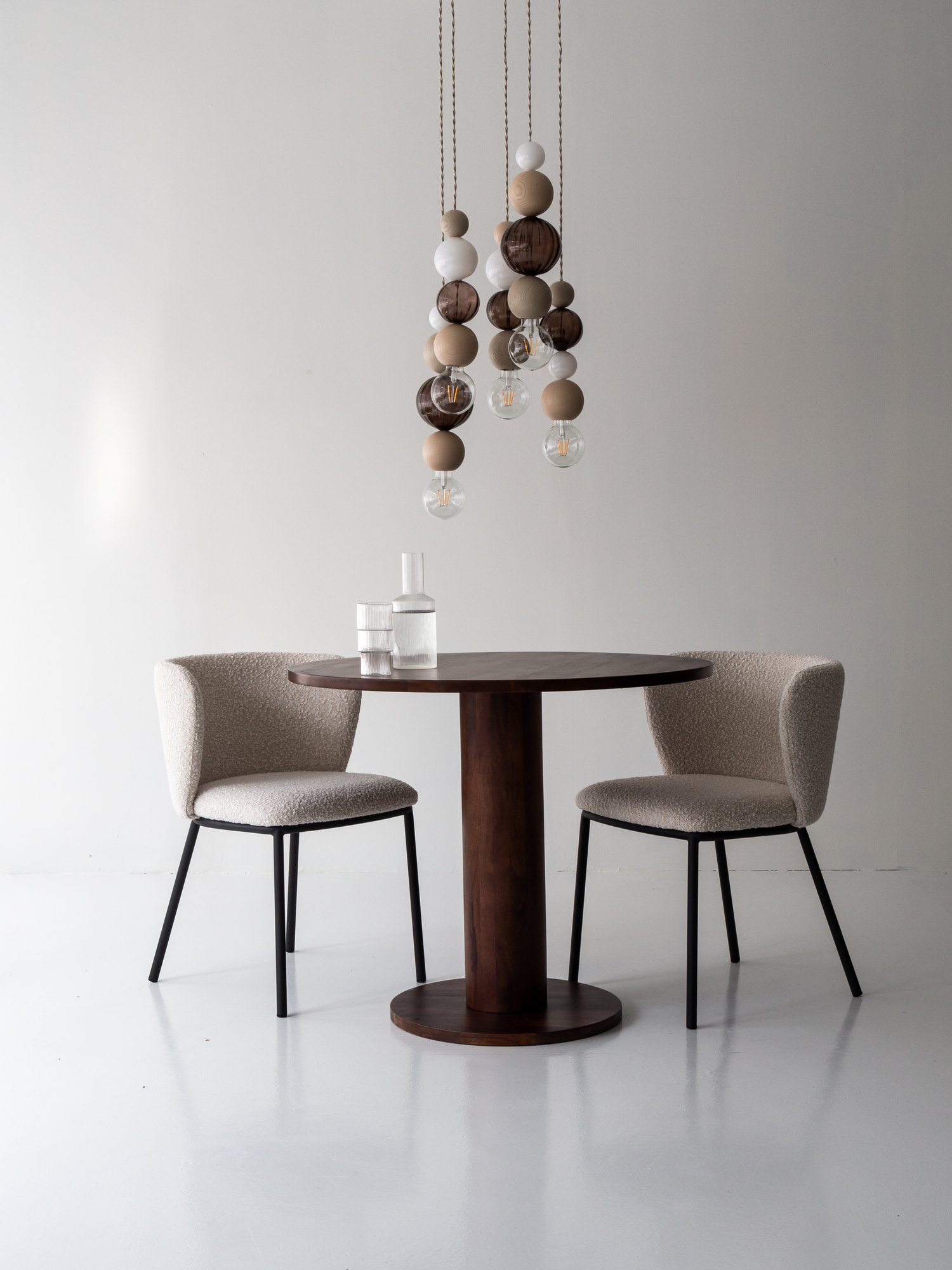QUU Design pendants above a round dining table